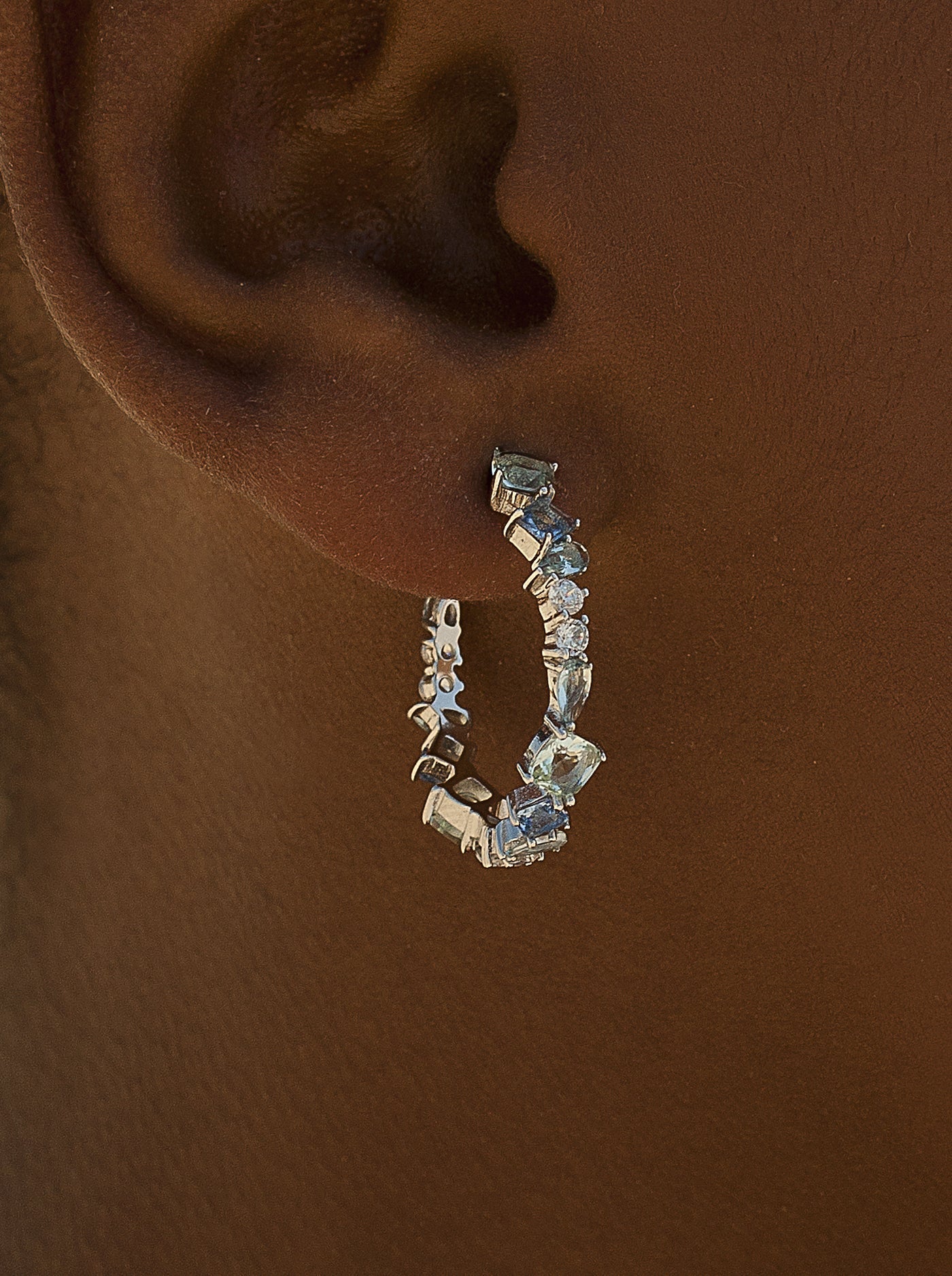 Small hoop earrings with aqua-toned gem design