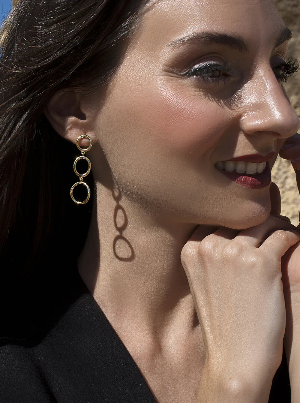 Long gold plated silver earrings with circular design