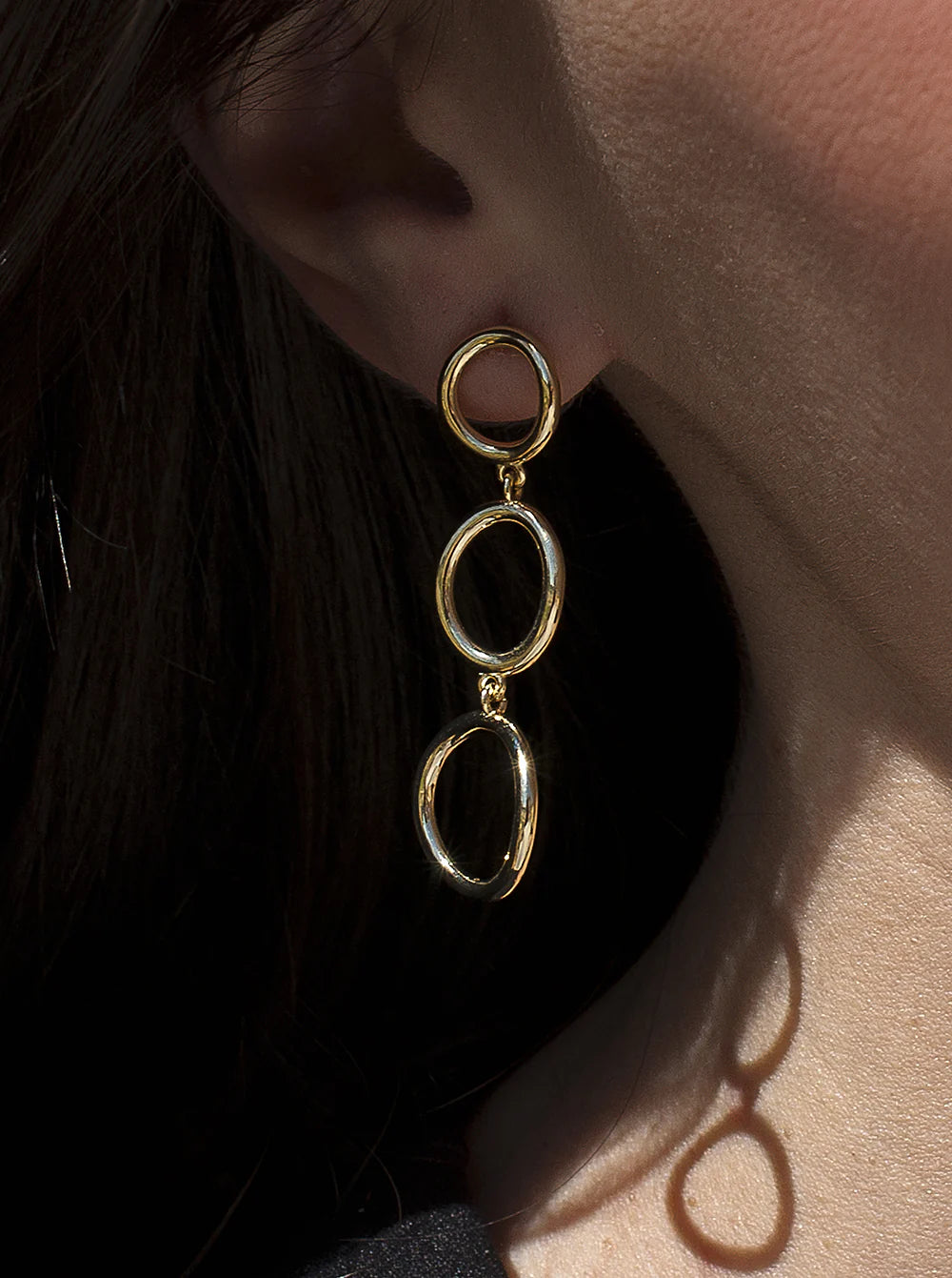 Long gold plated silver earrings with circular design