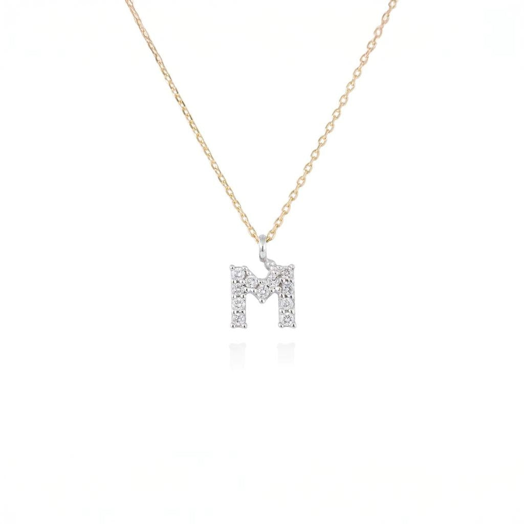 Penjoll lletra M de diamants en or groc i blanc 18kt 