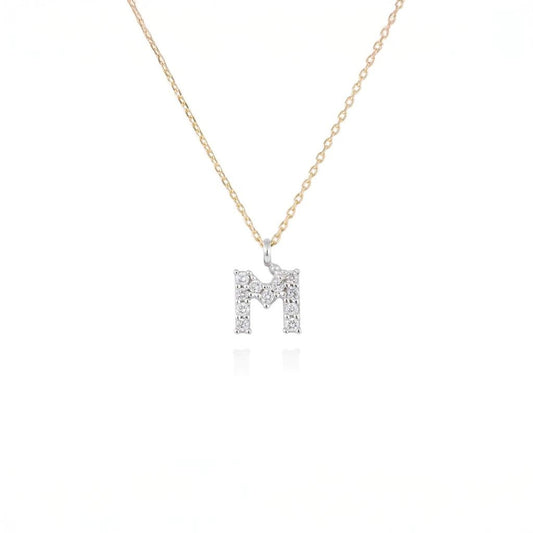 Penjoll lletra M de diamants en or groc i blanc 18kt 